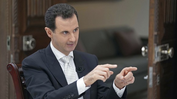 FILE - In this file photo released May 10, 2018, by the Syrian official news agency SANA, Syrian President Bashar Assad speaks during an interview with the Greek Kathimerini newspaper, in Damascus, Sy ...