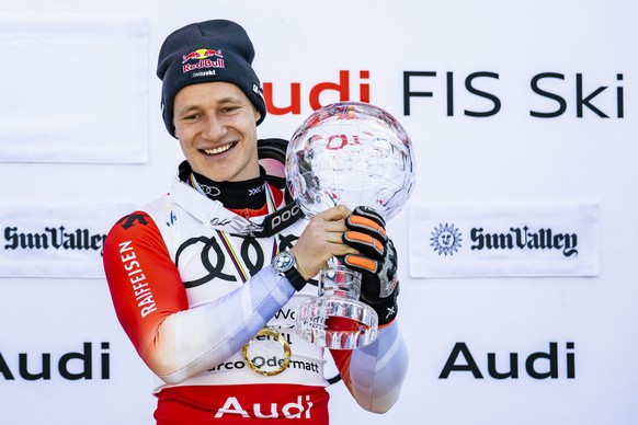 Marco Odermatt of Switzerland celebrates with men&#039;s World Cup overall crystal globe trophy during the podium ceremony at the FIS Alpine Ski World Cup Finals, in Sun Valley Resort, Idaho, United S ...