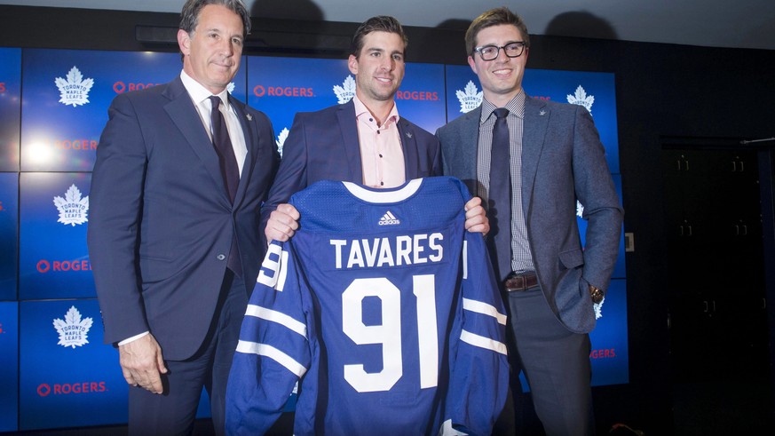 John Tavares, center, poses with Toronto Maple Leafs President Brendan Shanahan, left, General Manager Kyle Dubas following a news conference in Toronto, Sunday, July 1, 2018. Tavares is going home, a ...