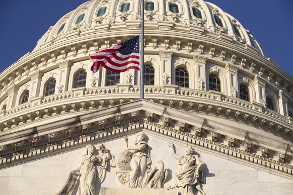 epa08933144 The US national flag is seen flying at half-staff at the US Capitol in Washington, DC, USA, 12 January 2021. At least ten thousand troops of the National Guard will be deployed in Washingt ...