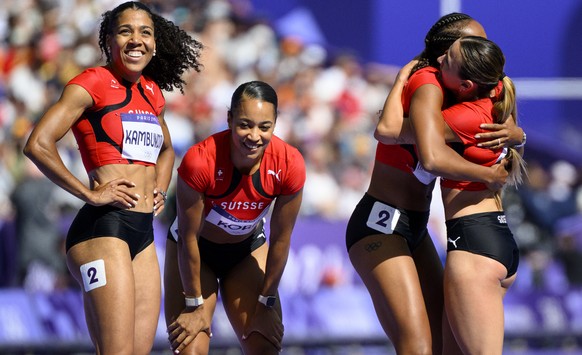 From left, Mujinga Kambundji, Salome Kora, Sarah Atcho-Jaquier and Leonie Pointet of Switzerland react after the women&#039;s 4 x 100m relay heats at the 2024 Paris Summer Olympics in Paris, France, T ...