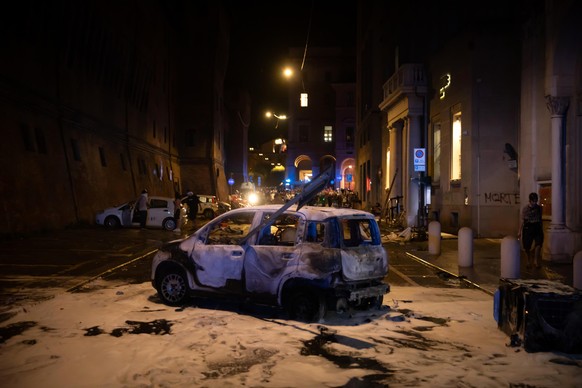 KEYPIX - epa13124094 A damaged car is seen during clashes between protesters and the police as part of a demonstration calling for justice for deceased Moroccan man Abderrahim Fakir, in Bologna, Italy ...