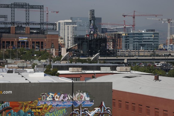 In this June 29, 2016 photo, cranes dot the landscape in downtown Denver. Richard Florida, a prominent urban theorist, argues that living in a booming city, with its high cost of living, can be toughe ...