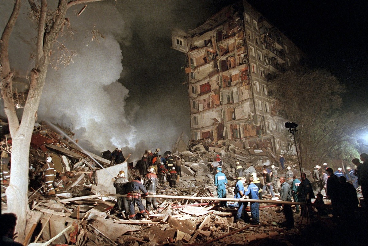 FILE - Smoke rises from an apartment building destroyed by a bomb blamed on Chechen militants, as Russian Emergency Situations Ministry officers and firefighters try to save people in Moscow, Russia,  ...