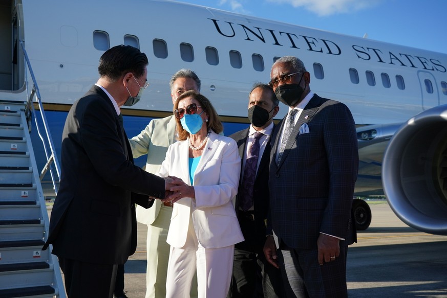 epa10103891 A handout photo made available by the Taiwan Ministry of Foreign Affairs shows Taiwan Foreign Minister Joseph Wu (R) shaking hands with US House Speaker Nancy Pelosi (C), before her depart ...