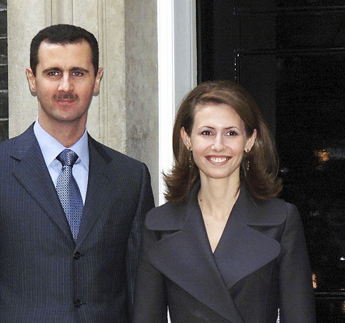 FILE - Syrian President Bashar Assad, left, and his wife Asma are greeted by Britain's Prime Minister Tony Blair outside his 10 Downing Street, London residence, Dec.16, 2002, on the start of the ...