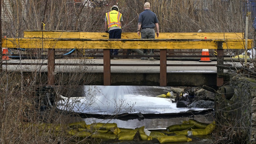HEPACO workers, an environmental and emergency services company, observe a stream in East Palestine, Ohio, Thursday, Feb. 9, 2023 as the cleanup continues after the derailment of a Norfolk Southern fr ...
