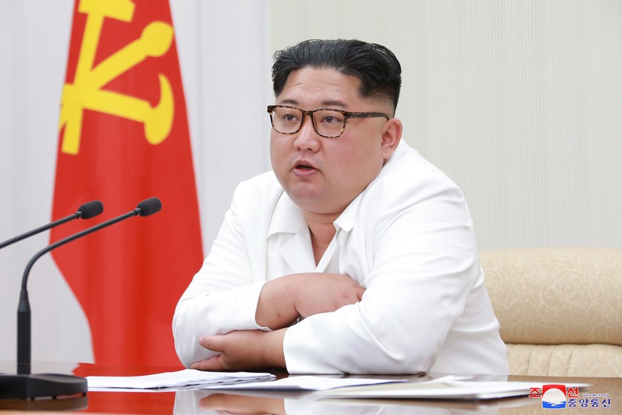 epa06745996 A photo released by the official North Korean Central News Agency (KCNA), the state news agency of North Korea, shows North Korean leader Kim Jong Un (C) chairing the first Enlarged Meetin ...