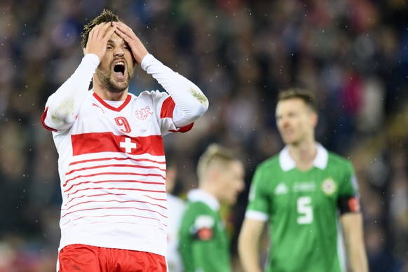 Switzerland&#039;s forward Haris Seferovic, left, reacts after missing a action in front of Northern Ireland&#039;s defender Jonny Evans, right, during the 2018 Fifa World Cup play-offs first leg socc ...