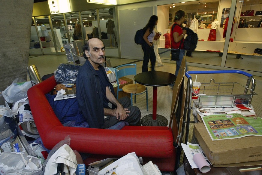 FILE - Merhan Karimi Nasseri sits among his belongings at Terminal 1 of Roissy Charles De Gaulle Airport, north of Paris on Aug. 11, 2004 . An Iranian man who lived for 18 years in Paris&#039; Charles ...