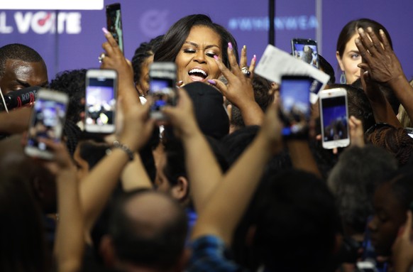 Former first lady Michelle Obama meets with people at a rally to encourage voter registration, Sunday, Sept. 23, 2018, in Las Vegas. (AP Photo/John Locher)