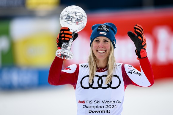 epa11238500 Cornelia Huetter of Austria celebrates with the women&#039;s downhill overall leader crystal globe trophy in the finish area during the women&#039;s downhill race at the FIS Alpine Skiing  ...