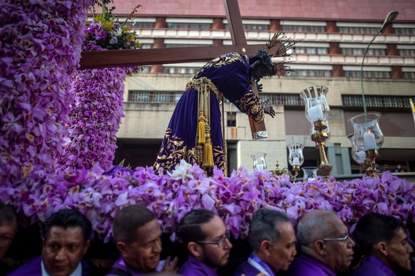 epa07513088 Parishioners and religious take part in the procession of the San Pablo Nazarene, decorated with approximately 3,000 orchids, at the Santa Teresa East Basilica, during the commemoration of ...