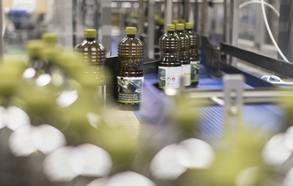 A bottling plant fills olive oil bottles in the Coop Food Production and Distribution Centre in Pratteln in the Canton of Basel-Landschaft, Switzerland, pictured on March 1, 2018. The largest producti ...