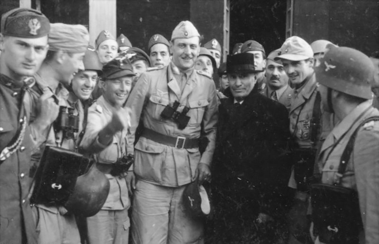 Benito Mussolini in front of Hotel Campo Imperatore with Otto Skorzeny (light uniform, binoculars) and Major Harald Mors (dark cap).  https://commons.wikimedia.org/wiki/Category:Fallschirmj%C3%A4ger_in_Gr...