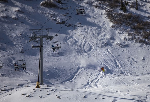 A skier cuts through the snow near the Treasure ski lift at Wolf Creek Ski Area in Pagosa Springs, Colo., Wednesday, Oct. 28, 2020. Wolf Creek is the first ski area in Colorado to open for the 2020-21 ...