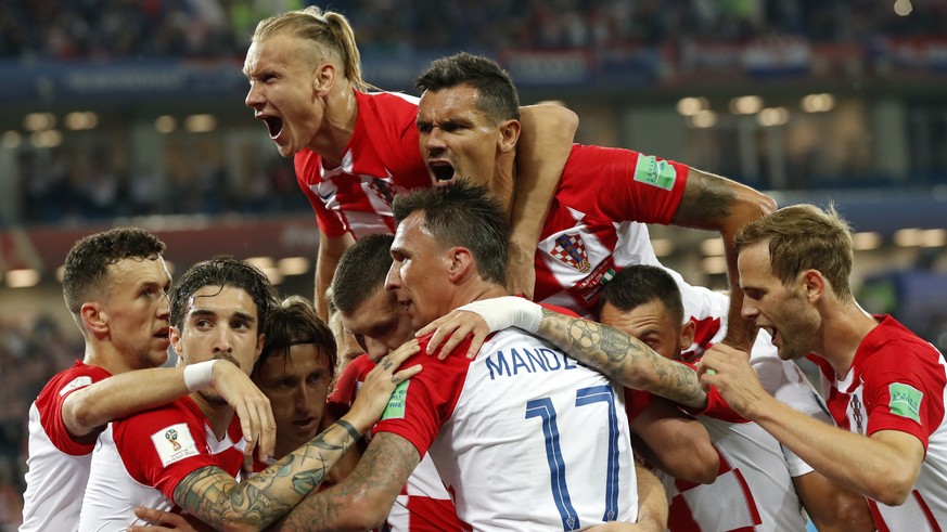 Croatia players celebrate after teammate Luka Modric, scoring from a penalty spot during the group D match between Croatia and Nigeria at the 2018 soccer World Cup in the Kaliningrad Stadium in Kalini ...