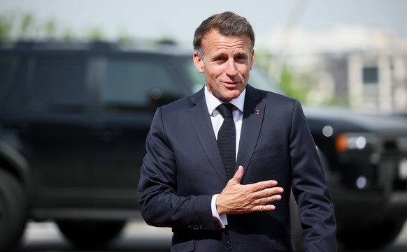epa12931256 French President Emmanuel Macron gestures during the welcome ceremony for the 8th European Political Community Summit, at the Karen Demirchyan Sports and Concert Complex in Yerevan, Armeni ...