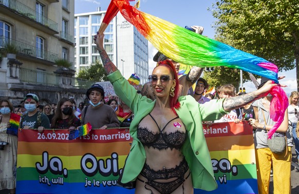 People walk through the streets for the rights of the LGBTIQ+ community during the Geneva Pride march, in Geneva, Switzerland, Saturday, September 11, 2021. (KEYSTONE/Salvatore Di Nolfi)