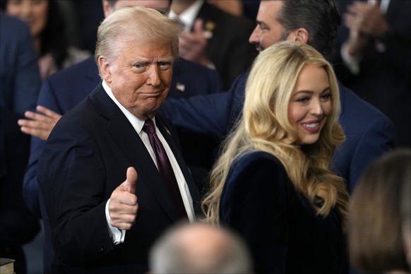 epa11839341 Donald Trump (L) reacts and Tiffany Trump smiles after being sworn in as the 47th president of the United States during the 60th Presidential Inauguration in the Rotunda of the U.S. Capito ...