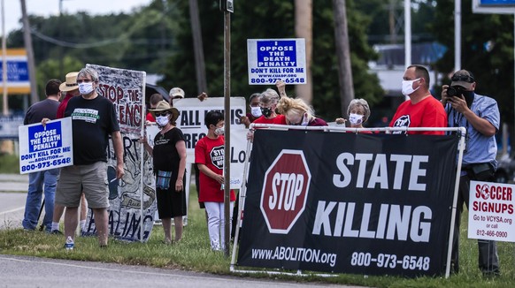 epa08544224 People gather to protest the resumption of federal executions near the US Penitentiary and execution chamber in Terre Haute, Indiana, USA, 13 July 2020. Three executions, the first in over ...