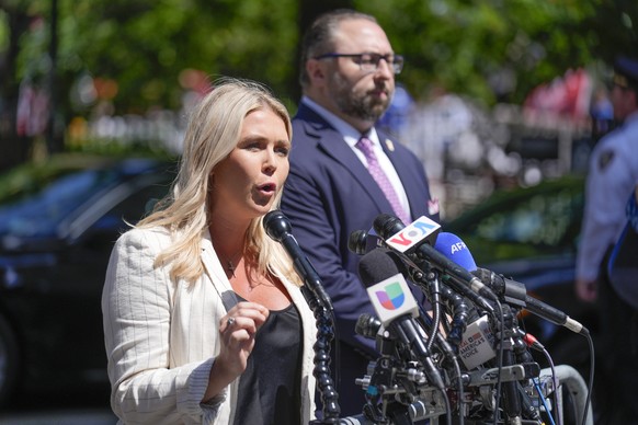 Karoline Leavitt, former President Donald Trump's campaign press secretary, speaks to reporters across the street from Trump's criminal trial in New York, Tuesday, May 28, 2024. (AP Photo/Se ...
