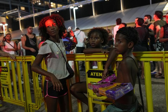 Children wait for the start of Madonna&#039;s last show of her The Celebration Tour, on Copacabana beach in Rio de Janeiro, Brazil, Saturday, May 4, 2024.(AP Photo/Silvia Izquierdo)