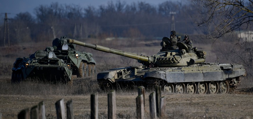 epa09782310 A T-72 battle tank and an armoured vehicle are seen at the Vay Adam training ground near Hajduhadhaz, Hungary 24 February 2022. Hungarian troops are being deployed to the eastern part of t ...
