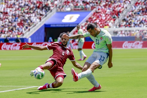 epa13035276 Qatar's Jassem Gaber, left, in action against Switzerland's Ricardo Rodriguez, right, during the FIFA World Cup 2026 group stage match Qatar against Switzerland, in San Francisco ...