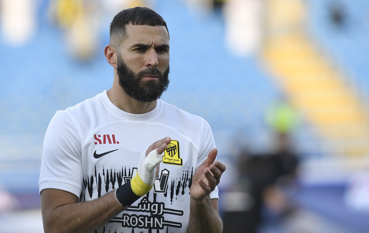 Al Ittihad's Karim Benzema greets fans during his team match against Al Raed in the Saudi Professional League, in Buraidah, Saudi Arabia, Monday, Aug. 14, 2023. (AP Photo)