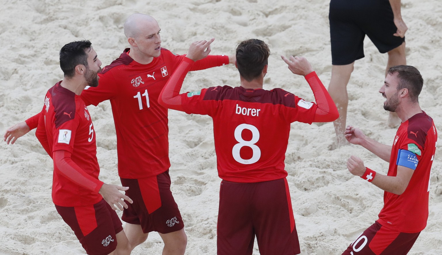 epa09430469 Players of Switzerland celebrate a goal during the FIFA Beach Soccer World Cup 2021 quarter final match between Uruguay and Switzerland at Luzhniki Beach Soccer Stadium in Moscow, Russia,  ...