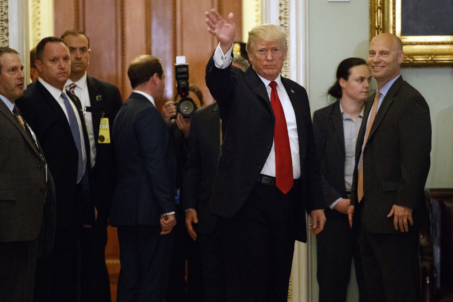President Donald Trump waves to reporters after a lunch with Republican senator at the U.S. Capitol Tuesday, Oct. 24, 2017, in Washington. (AP Photo/Evan Vucci)