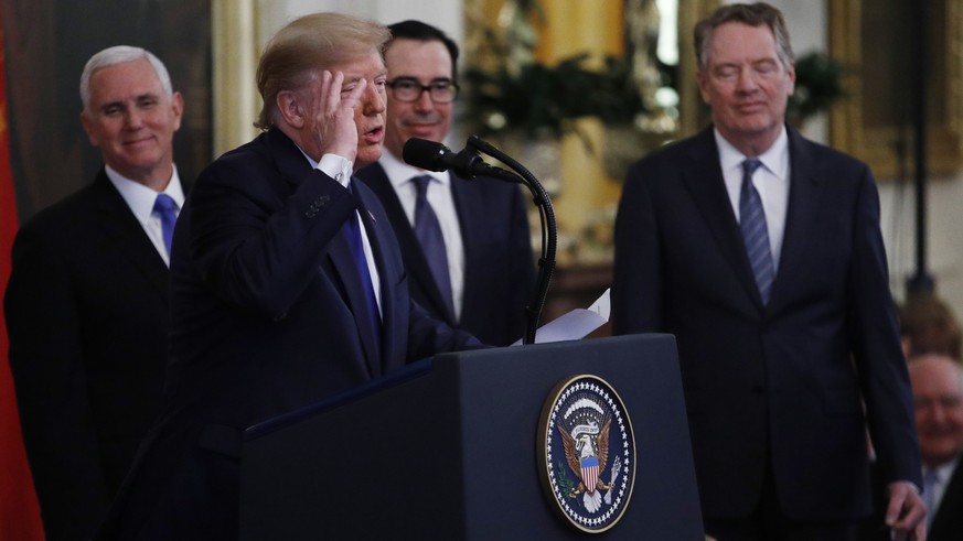 President Donald Trump, gestures, as Vice President Mike Pence, back left, Secretary of Treasury, Steven Mnuchin, back center, and U.S. Trade Representative Robert Lighthizer, right, listen during a s ...