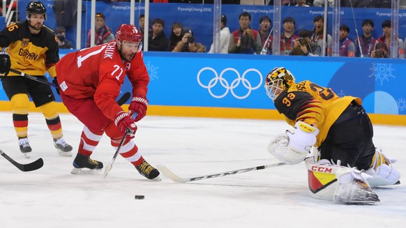 epa06563308 Ilya Kovalchuk of OAR (L) in action against Danny aus den Birken of Germany during the Men&#039;s Ice Hockey Gold Medal Game between the Olympic Athlete from Russia (OAR) and Germany at th ...