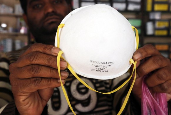 epa08200091 A vendor shows a mask N 95 at medical store in Bhopal, India, 07 February 2020. According to the news reprots, all India food and drug license association (AFDLH) seeks ban on exports of s ...