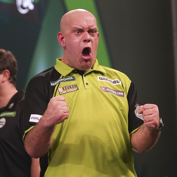 Michael van Gerwen of the Netherlands celebrates after winning his round 4 match against Jeffrey De Graaf of Sweden at the World Darts Championship in London, Monday, Dec. 30, 2024. (AP Photo/Alberto  ...