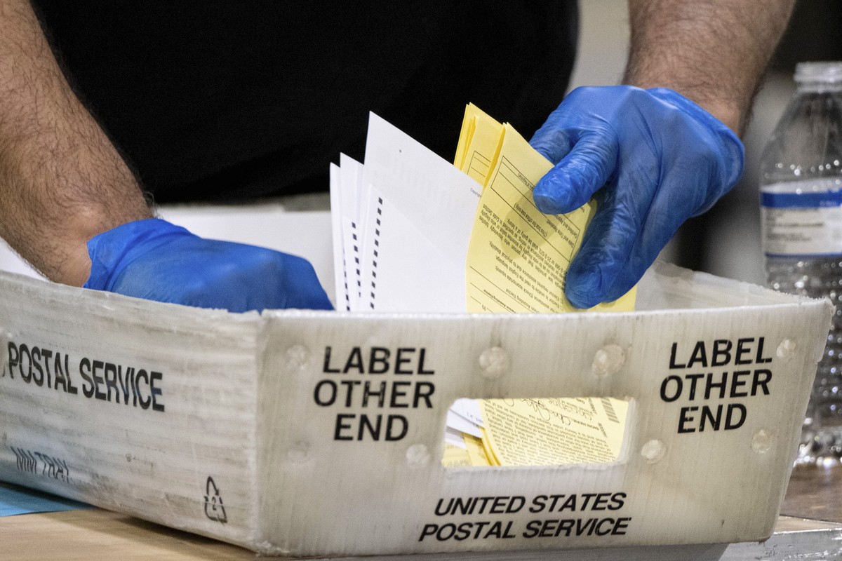 Fulton County Georgia elections workers process absentee ballots for the Senate runoff election in Atlanta on Tuesday, Jan. 5, 2021. Georgia's two Senate runoff elections on Tuesday will determin ...