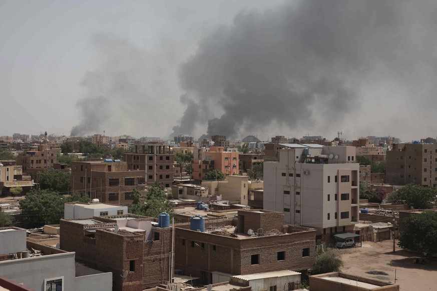 Smoke rises from a central neighborhood of Khartoum, Sudan, Sunday, April 16, 2023, after dozens have been killed in two days of intense fighting. The Sudanese military and a powerful paramilitary gro ...