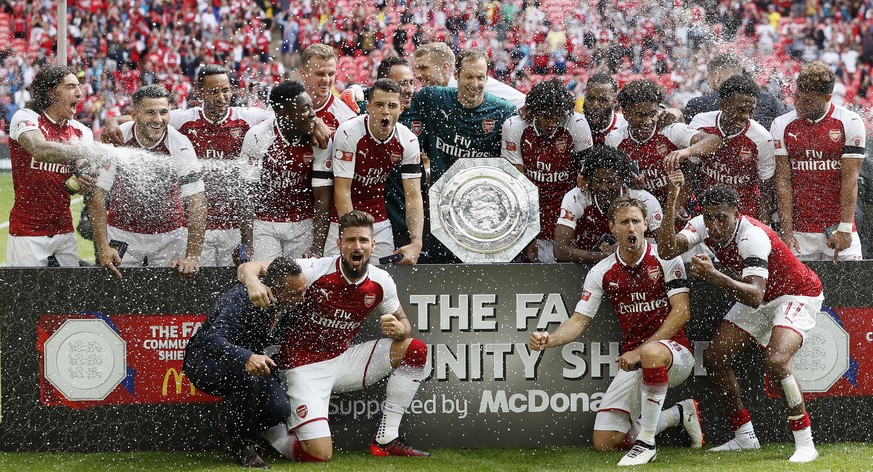 Arsenal players pose with the trophy after winning the English Community Shield soccer match between Arsenal and Chelsea at Wembley Stadium in London, Sunday, Aug. 6, 2017. (AP Photo/Kirsty Wiggleswor ...