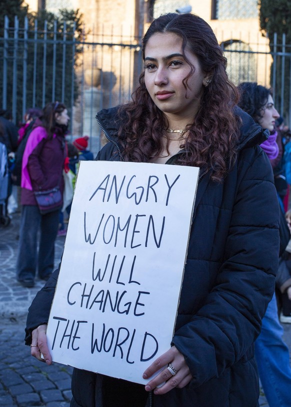 March 8, 2022, Rome, Italy: A protester holds a placard expressing her opinion, during the Women s march to celebrate International Women s Day in Rome..People displayed placards and banners demanding ...