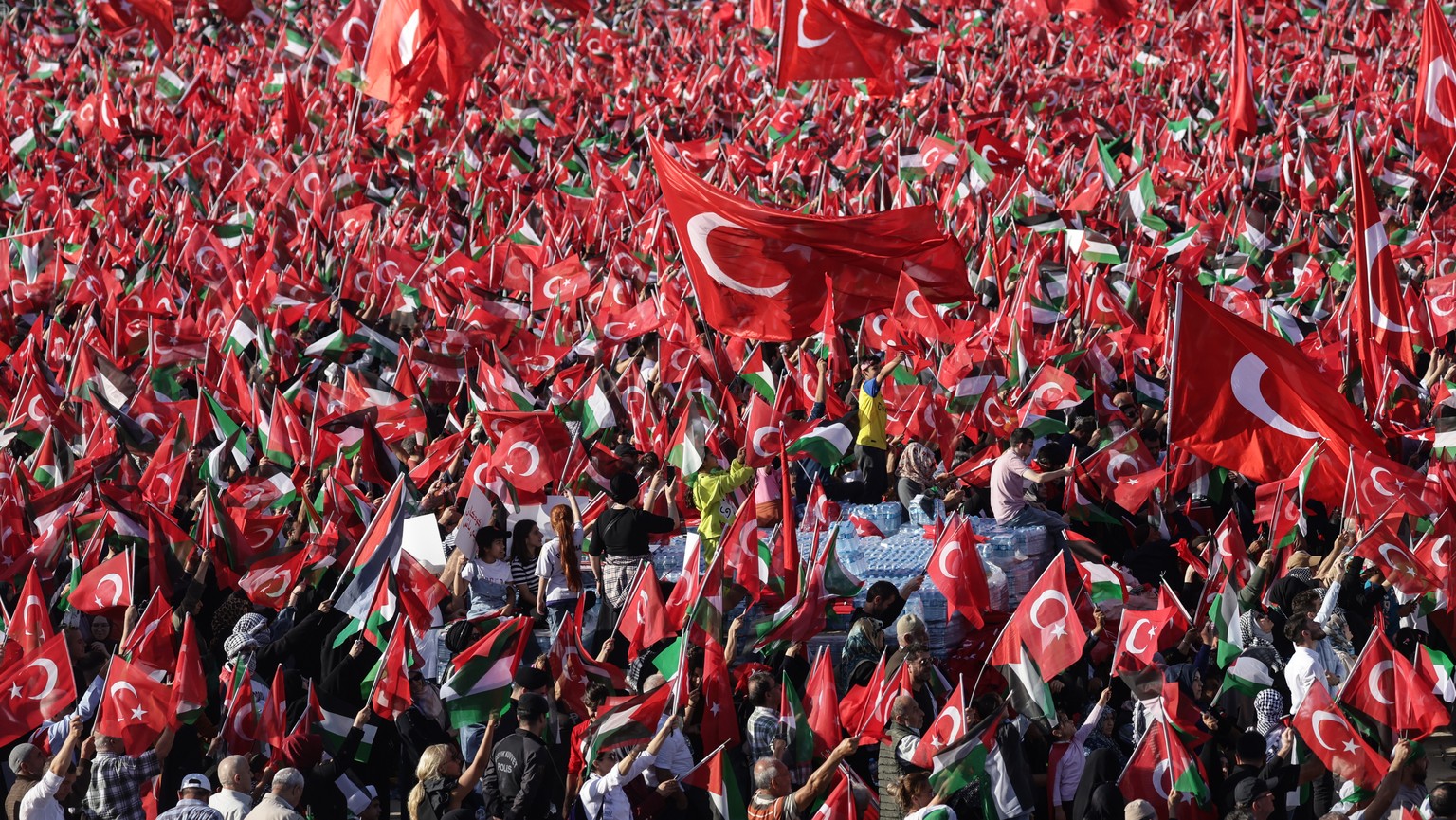epa10945556 Supporters of Turkish President Recep Tayyip Erdogan hold Turkish and Palestinian flags during a pro-Palestinian rally at the Ataturk Airport in Istanbul, Turkey, 28 October 2023. Thousand ...