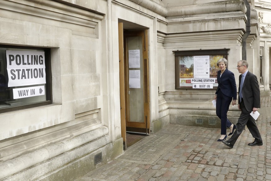 British Prime Minister Theresa May and her husband Philip arrive to vote in local council elections at a polling station at Methodist Central Hall in London, Thursday, May 3, 2018. (AP Photo/Matt Dunh ...