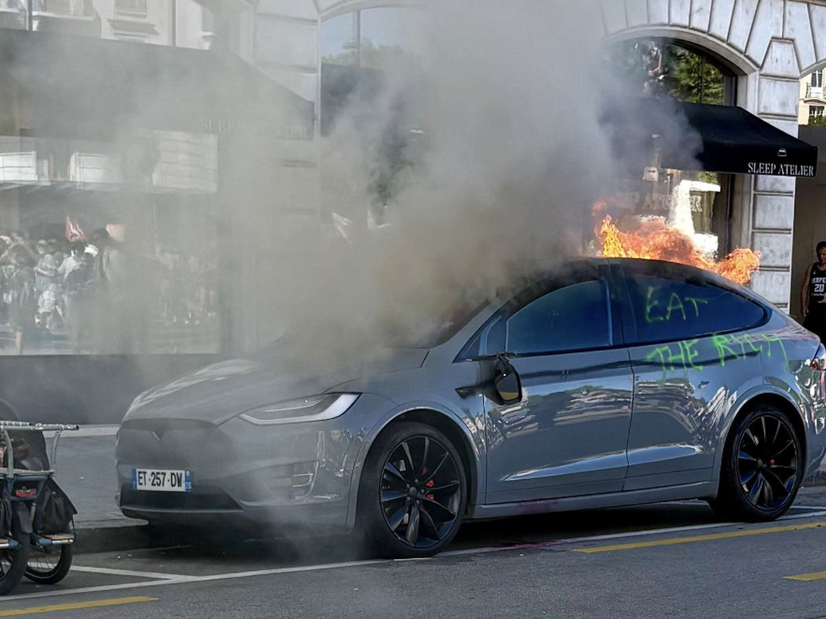 Un manifestant vient de bouter le feu à une voiture parquée à la rue Ami-Lévrier, face à la gare routière de Genève.