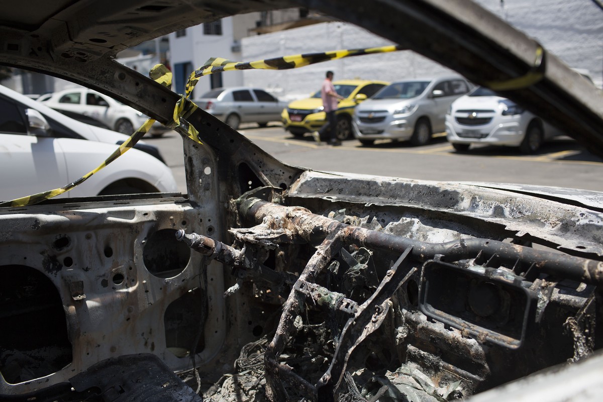 A burned car sits in the parking lot of the police station in Belford Roxo, Brazil, Friday, Dec. 30, 2016. This burned vehicle, matching the description of the car rented by Greece's ambassador t ...
