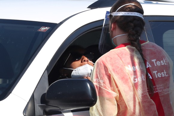 epa08646683 A person in a vehicle is tested with a swab at a drive-thru COVID-19 testing site operated by the District of Columbia, in Washington, ?DC, USA, 04 September 2020. Two unidentified vaccine ...