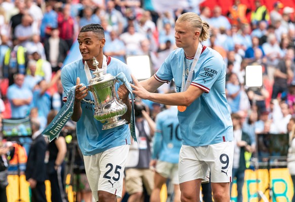Manuel Akanji of Man City and Erling Haaland of Man City celebrate with the FA Cup during the FA Cup final match between Manchester City and Manchester United, ManU at Wembley Stadium, London, England ...
