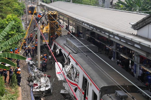 Workers use a heavy machine to remove the wreckage of a train after a collision in Bekasi, Indonesia, Tuesday, April 28, 2026. (AP Photo/Tatan Syuflana)
Indonesia Train Crash