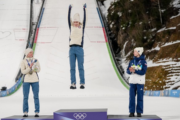 Gold medalist Anna Odine Stroem, of Norway, celebrates on the podium flanked by silver medalist Eirin Maria Kvandal, also of Norway, and bronze medalist Nika Prevc, of Slovenia, right, after the ski j ...