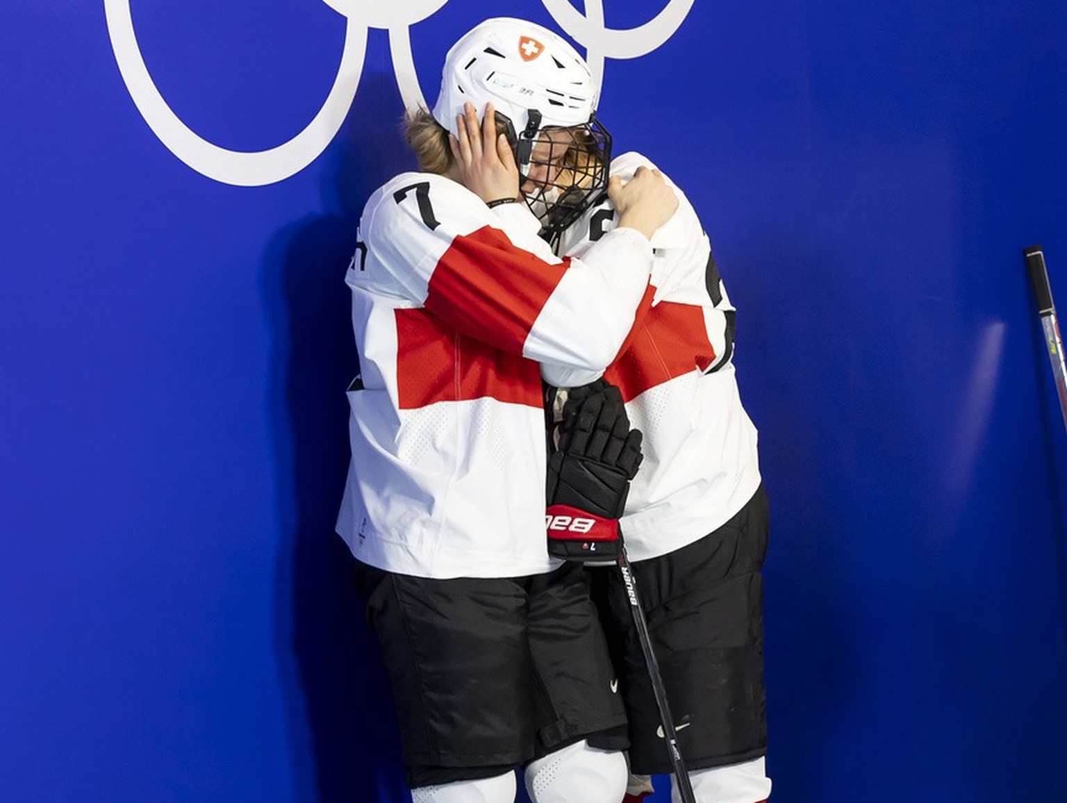 Switzerland&#039;s forward Lara Stalder #7 and Switzerland&#039;s forward Alina Mueller, comfort each after losing the women&#039;s ice hockey Bronze Medal game between Finland and Switzerland at the  ...
