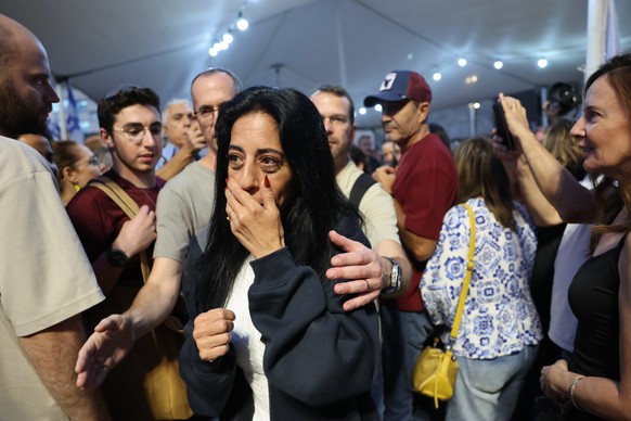 epa12442278 Einav Zangauker, the mother of hostage Matan Zangauker, as people celebrate after a peace deal is announced at Hostages Square in Tel Aviv, Israel, 09 October 2025. US President Donald Tru ...